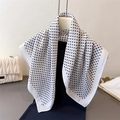 Elegant white polka dot scarf displayed on a mannequin with a minimalist fashion aesthetic - White