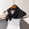 French style polka dot silk scarf tied on a white vest with a quilted chain bag - Black