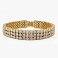 Pulsera tennis dorada de tres filas con circonitas blancas brillantes sobre fondo blanco - Pulsera Tennis de Tres Filas de Circonitas / Dorado