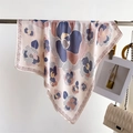 Close-up of floral silk-like scarf with geometric borders and chains on a display rod - 70*70cm / FG17-3 Lotus Pink Abstract Floral
