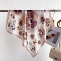 Detail of floral silk-feel scarf with geometric borders draped on a metal rack - 70*70cm / FG17-4 Earth Tone Abstract