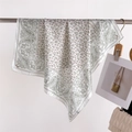 Detail of paisley print silk-like scarf draped on a metal rack with artistic props - FG15-1 White