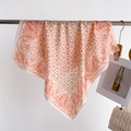 Elegant paisley print silk square scarf in orange and beige hanging with chic fashion bag - FG15-3 Orange