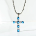 Detail of square-cut blue and white zircon stones set in a silver cross pendant necklace - Blue And White Zirconia