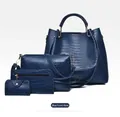 Macro shot of 4-piece dark blue crocodile embossed leather tote and purse set - Blue