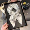 Elegant white silk scarf with black polka dots tied in a bow on a display tray - White Polka Dot (FG11-4)