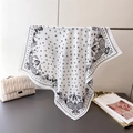 Detail of white paisley square scarf hanging with stars and geometric patterns - White
