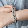 Close-up of 13mm silver iced out Cuban link bracelet with sparkling rhinestones on wrist - Silver (19cm)