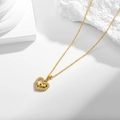 Golden heart necklace with zircon inlay and LOVE engraving on a minimalist background - Heart LOVE Pendant Necklace (N0080)