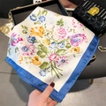 Elegant white square silk scarf featuring colorful floral print and bright blue borders - 70cmx70cm / Blue