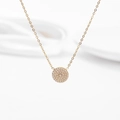 Macro detail of gold circular pendant with paved sparkling crystals and fine chain - Full Zirconia Circle Style / Gold