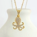Macro shot of gold octopus pendant with pavé white zircon stones on a simple cross chain - Gold Octopus (N0403G)