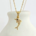 Macro shot of a gold dolphin pendant with sparkling white zircons on a fine O-chain - Gold Dolphin (N0404G)