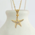 Macro shot of gold starfish pendant with cubic zirconia stones on stainless steel chain - Gold Starfish (N0405G)
