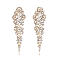 Vintage long tassel earrings with sparkling rhinestones in gold finish on white background - Gold
