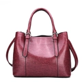 Polished wine red patent leather handbag with dual handles and silver hardware - Burgundy