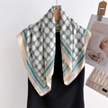 Geometric chain print silk square scarf in green and beige hanging on wooden hanger - Beige