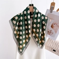 Detailed texture of dark green silk scarf with white polka dots and orange border edges - Dark Green Polka Dot Print