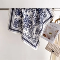 Classic Toile de Jouy tree and animal pattern square silk scarf displayed with a bag - Blue