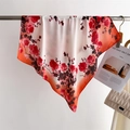 Detailed view of square silk scarf with red floral pattern and gradient orange edges - Red Rose Print