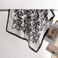 Detail view of square scarf showing rose print and polka dot patterns with silky texture - 66-70cm / Black