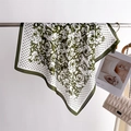 Polka dot and rose print silk scarf draped elegantly over a metal bar for home styling - 66-70cm / Green