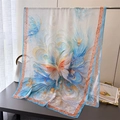 Detail of silk scarf with artistic butterfly prints and intricate red border patterns - Blue