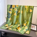 Macro shot of green silk scarf featuring golden lotus print and light floral texture - Emerald Green (Yellow Lotus Pattern)