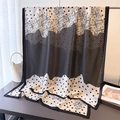 Detail of black and white geometric silk scarf draped elegantly over a display stand - Black Polka Dot / 180*80cm