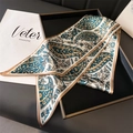 Classic paisley long silk scarf in dark green and beige, elegantly styled on a tray - Green Paisley