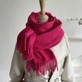 Close-up of rose red wool scarf texture with long tassels on a beige winter coat - Rose Red