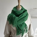 Detail of grass green knitted scarf with long fringes paired with a white fleece coat - Emerald Green