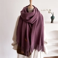 Detailed view of the dark purple wool scarf texture and brown leather label on the fabric - Deep purple