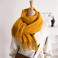 Detail of ginger yellow knitted scarf with long fringe tassels on a wooden mannequin - Ginger Yellow