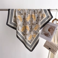 Yellow paisley and houndstooth pattern square silk scarf displayed on a metal rack - Coffee Black Border (FJ960-6)