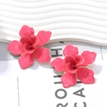 Macro shot of 3D hot pink enamel flower earrings with gold-edged petals and luxury finish - Rose Red