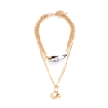 Mehrlagige goldene Kette mit Hornanhänger, Münze und Perle auf weißem Hintergrund - Gold