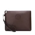 Detail view of dark brown pebbled leather texture with embossed circular brand logo - Bark Pattern Style 1 / Dark Brown (Bark Pattern)