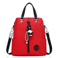 Versatile red nylon backpack for women with black handles and bear charm accessory - Red