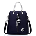 Versatile navy blue nylon backpack for women with silver handles and bear charm - Royal Blue
