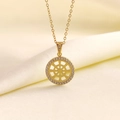 Collana in acciaio titanio dorato con pendente tondo traforato e zirconi su sfondo seta - Ruota del Dharma Dorata Zirconia