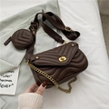 Close-up of brown quilted crossbody bag with gold metal turn-lock and woven strap - Coffee