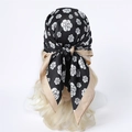 Detailed view of silk square scarf with camellia print worn as elegant headscarf - 90x90cm / Black Camellia Style (FN251-4)