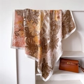 Detalle de pañuelo de seda con estampado de leopardo y paisaje sobre un soporte - 90x90cm / Marrón