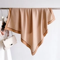 Elegant silk scarf with V-pattern hanging on a rack with a white chain bag - 90x90cm / Khaki