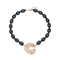 Chunky black beaded necklace featuring a large textured gold-tone C letter pendant - Black and Gold (A)