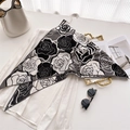 Detail of floral velvet scarf with rose pattern styled on white shirt and accessories - Black