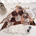 Elegant velvet scarf with large floral rose print styled over a white blouse and accessories - Brown