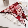 Red and cream floral velvet scarf draped over a white silk shirt on a minimal desk - Red