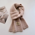 Détail d'une écharpe en maille beige avec bords côtelés et étiquette de marque vintage - Poche zippée